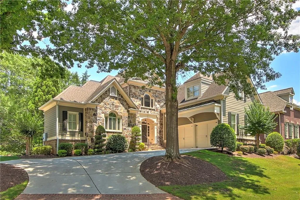View of front of home featuring a garage and a front lawn