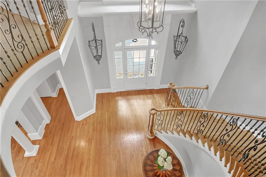 Entryway with a high ceiling, a chandelier, and hardwood / wood-style flooring