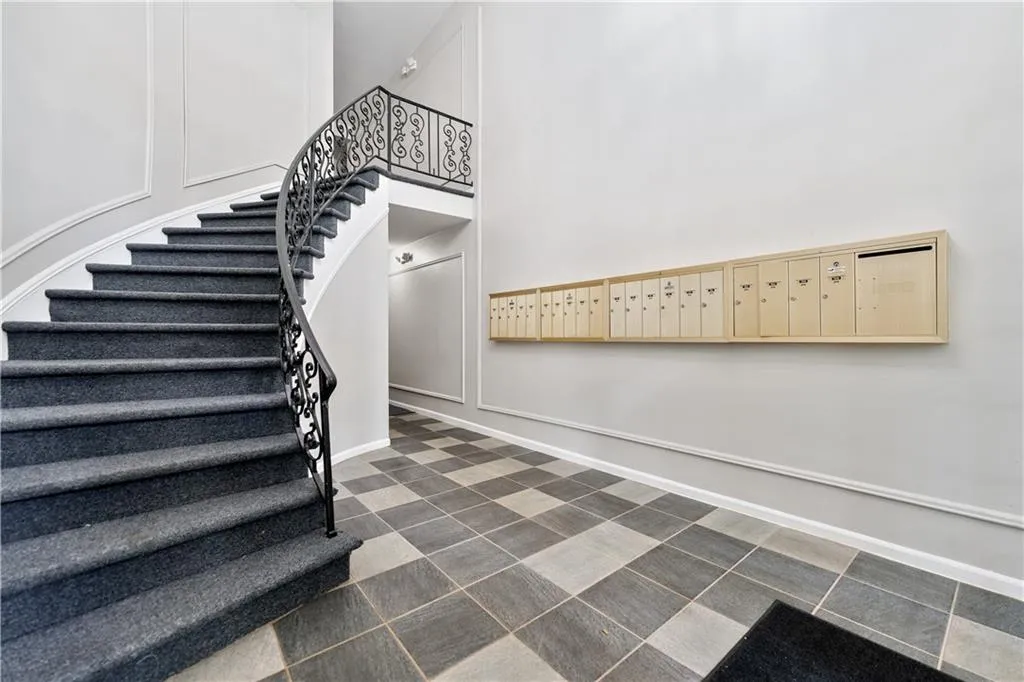 Stairs featuring mail area and a towering ceiling