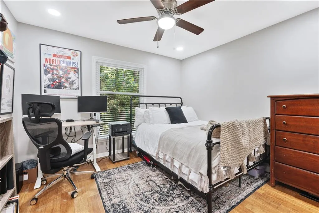 Bedroom with light wood-style flooring, a desk, recessed lighting, and ceiling fan