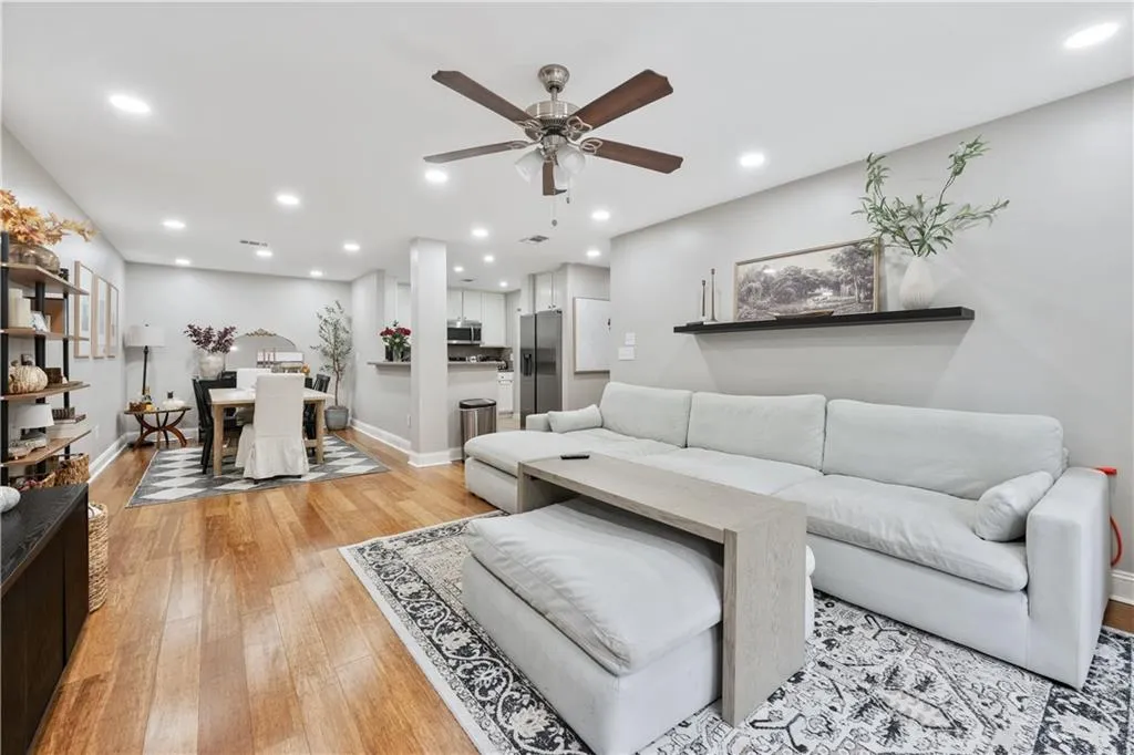 Living room with light wood-style flooring, recessed lighting, and a ceiling fan