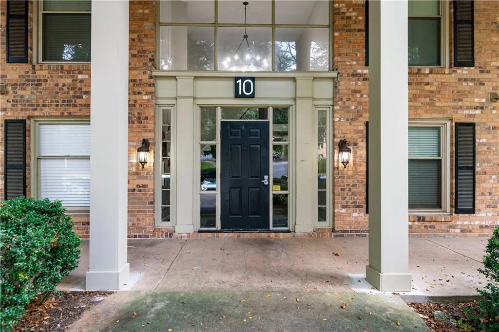 View of exterior entry with brick siding