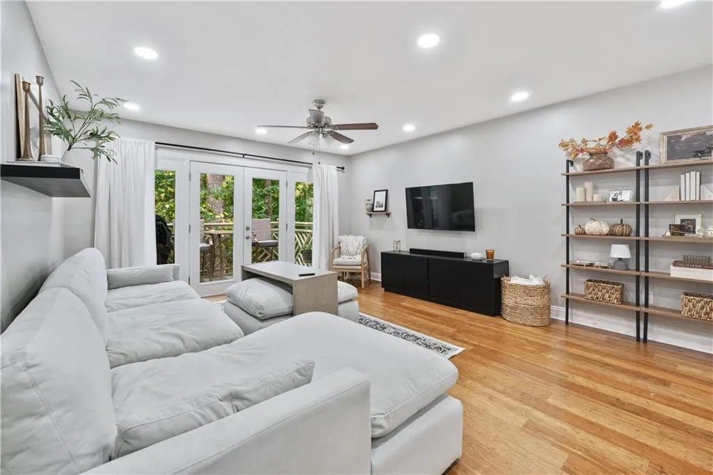 Living room with recessed lighting, light wood-style flooring, a ceiling fan, and french doors