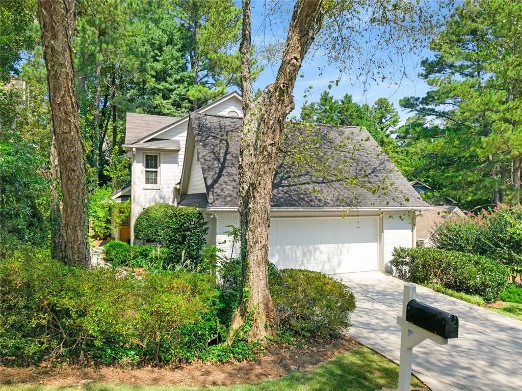 There is a meandering sidewalk that takes you to the front door. Pretty side yard creates private garden magic!