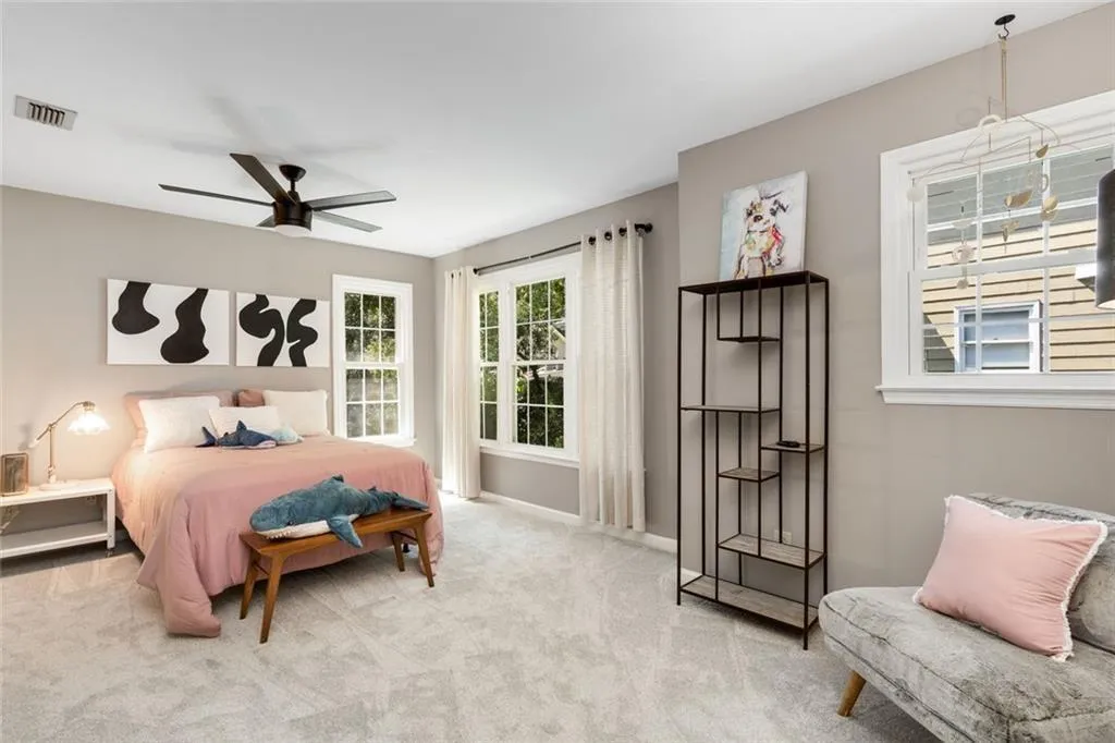 One of two secondary bedrooms upsatirs. This room has a nice area that would be great for childsplay or a study nook. A double closet provides good storage too!  All the windows keep the interior bright and happy!
