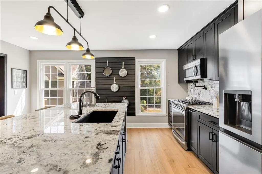 Custom designer lighting and hardware. The sink area even has a Bar Glass washer! All cabinetry is Soft Open/Close. Custom pull out racks and shelving with the cabinets too!