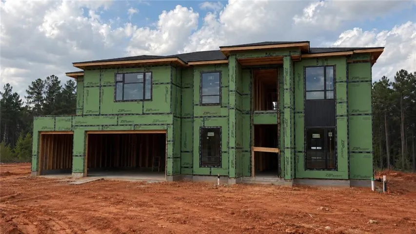 Modern two-story new construction featuring a partial black roof, black-framed windows, and an integrated two-car garage