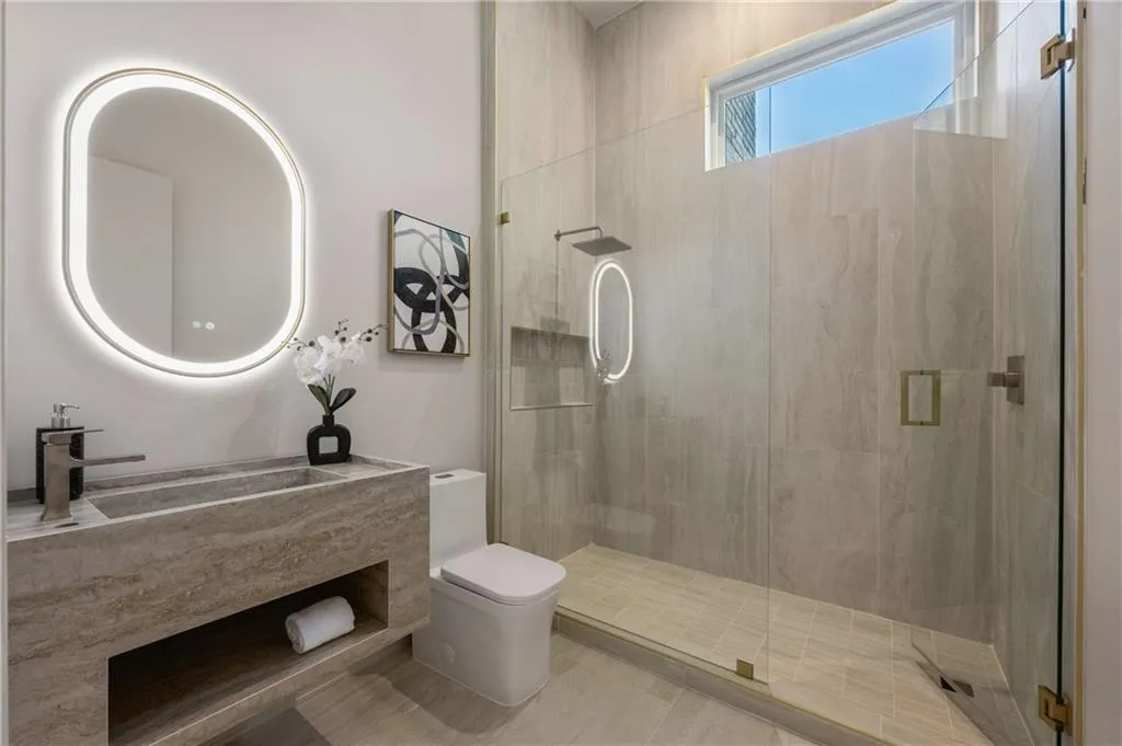 Luxurious full bathroom off the office, creating a versatile space that can easily serve as an additional main-floor bedroom or private guest suite. Luxurious full bathroom off the office, creating a versatile space that can easily serve as an additional main-floor bedroom or private guest suite.