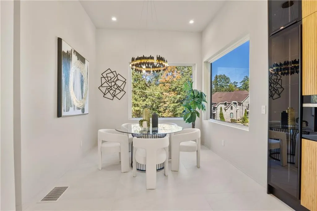Beautifully designed breakfast room with custom lighting and large windows, seamlessly connecting to the kitchen for a perfect, open-concept flow. Beautifully designed breakfast room with custom lighting and large windows, seamlessly connecting to the kitchen for a perfect, open-concept flow.