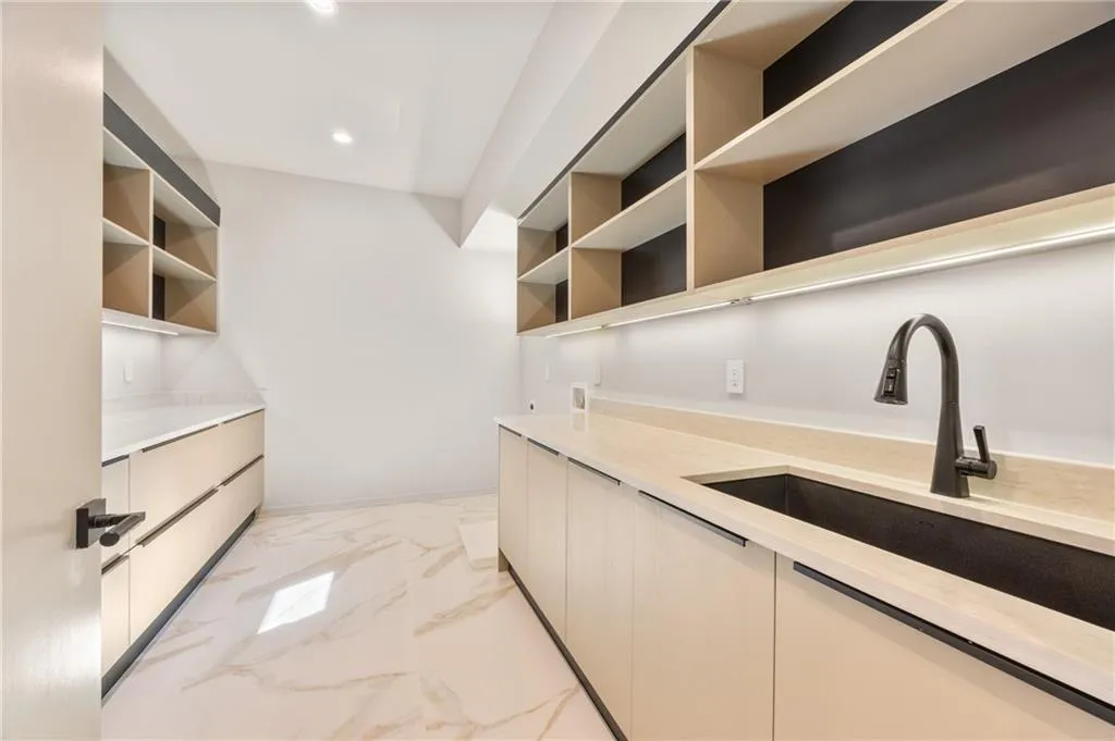 Expansive upper-level laundry room with abundant storage and workspace, offering both functionality and comfort for effortless, enjoyable laundry time. Expansive upper-level laundry room with abundant storage and workspace, offering both functionality and comfort for effortless, enjoyable laundry time.