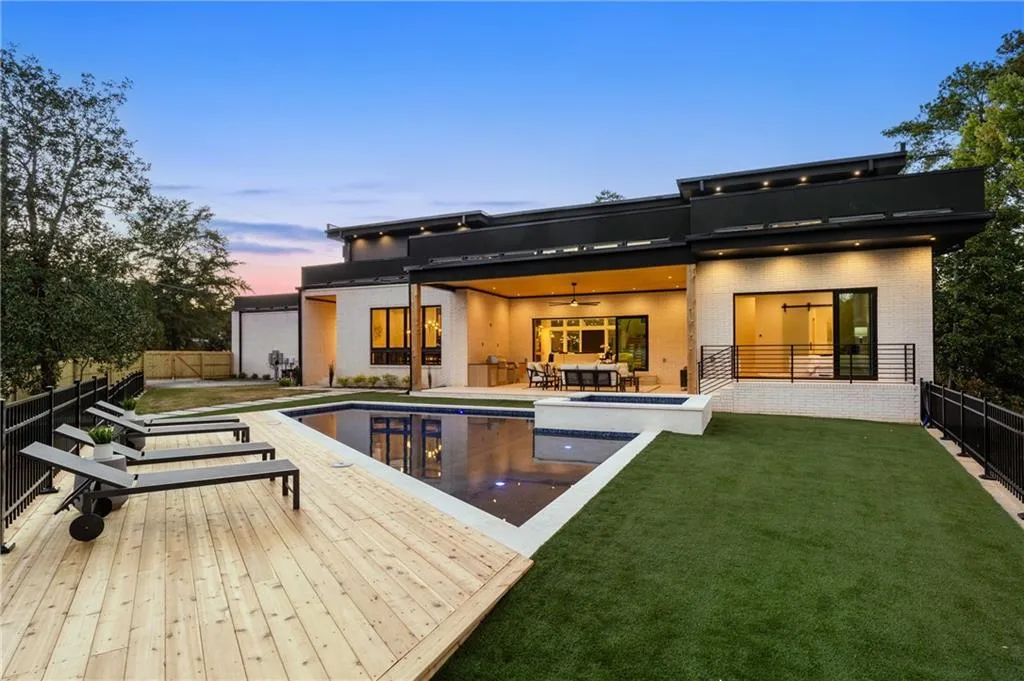 Back of house at dusk with a fenced backyard, ceiling fan, brick siding, and a patio Back of house at dusk with a fenced backyard, ceiling fan, brick siding, and a patio