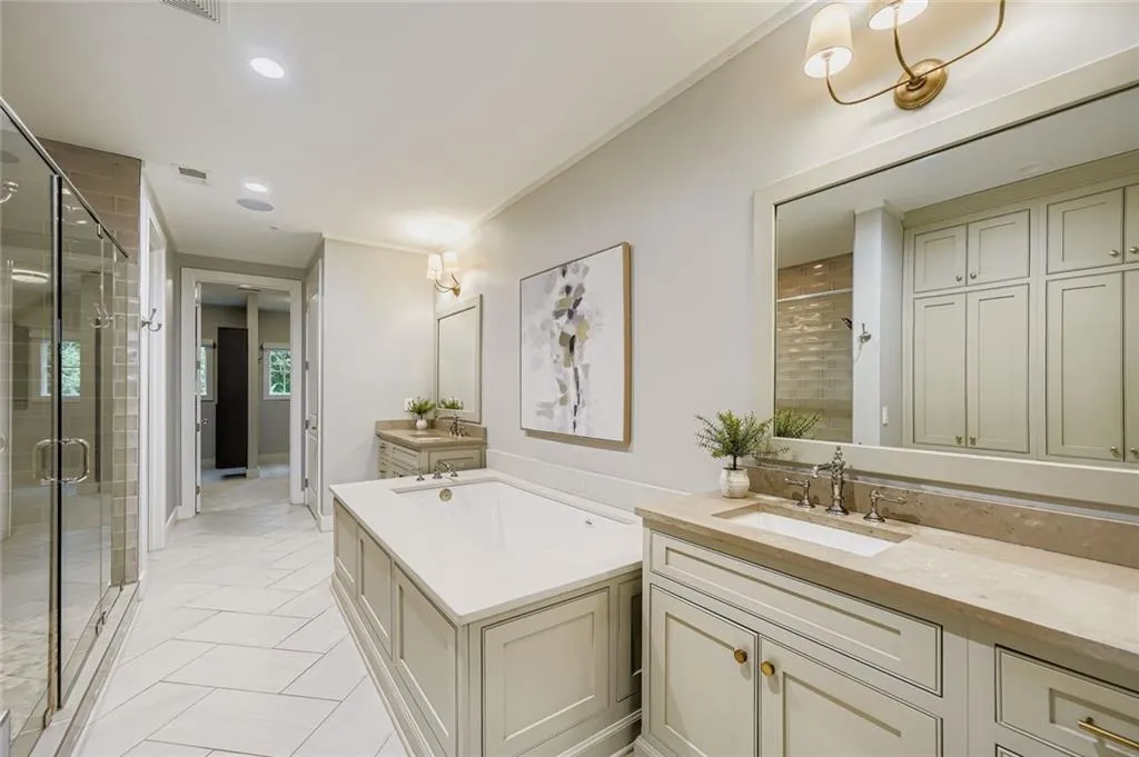 Bathroom with vanity, a shower stall, crown molding, a bath, and recessed lighting
