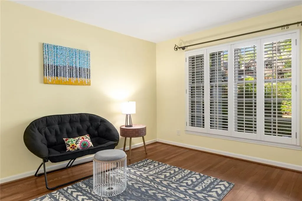 A secondary bedroom on the main level is perfect for out-of-town guests or extended stays, with a full bath conveniently located just across the hall.