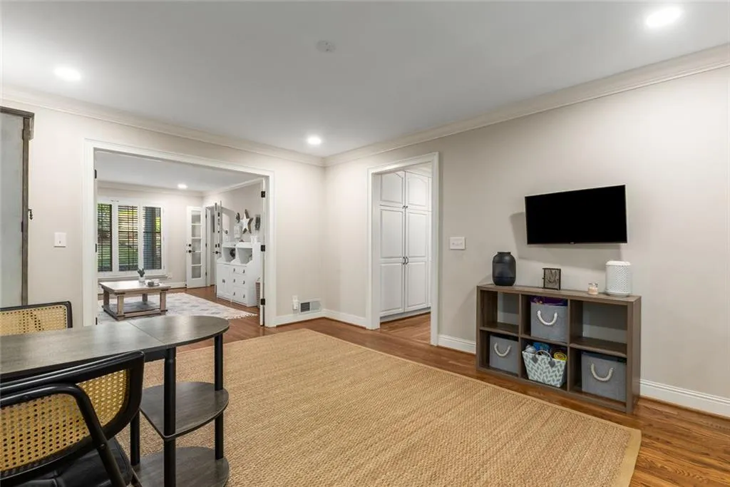 The formal dining room is currently being used as a playroom. It opens to the screened porch, offering a seamless flow into your own private oasis.