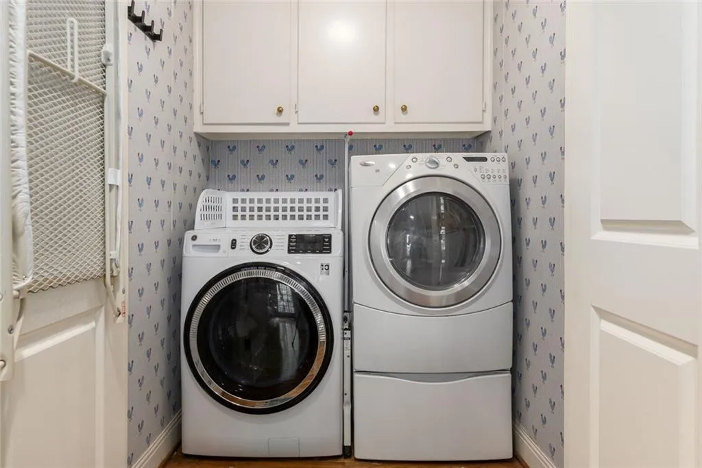 The laundry room is conveniently located off the kitchen and includes built-in storage.