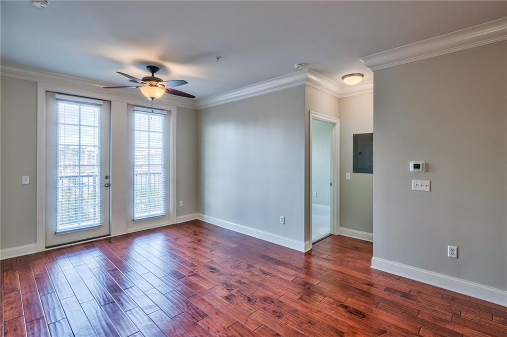 Unfurnished room with plenty of natural light, dark hardwood / wood-style flooring, and ceiling fan