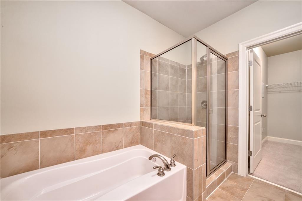 Bathroom with tile floors and plus walk in shower