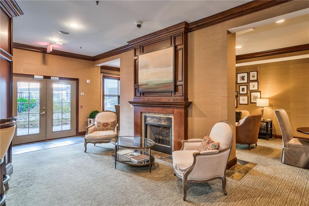 Carpeted living room with crown molding and french doors