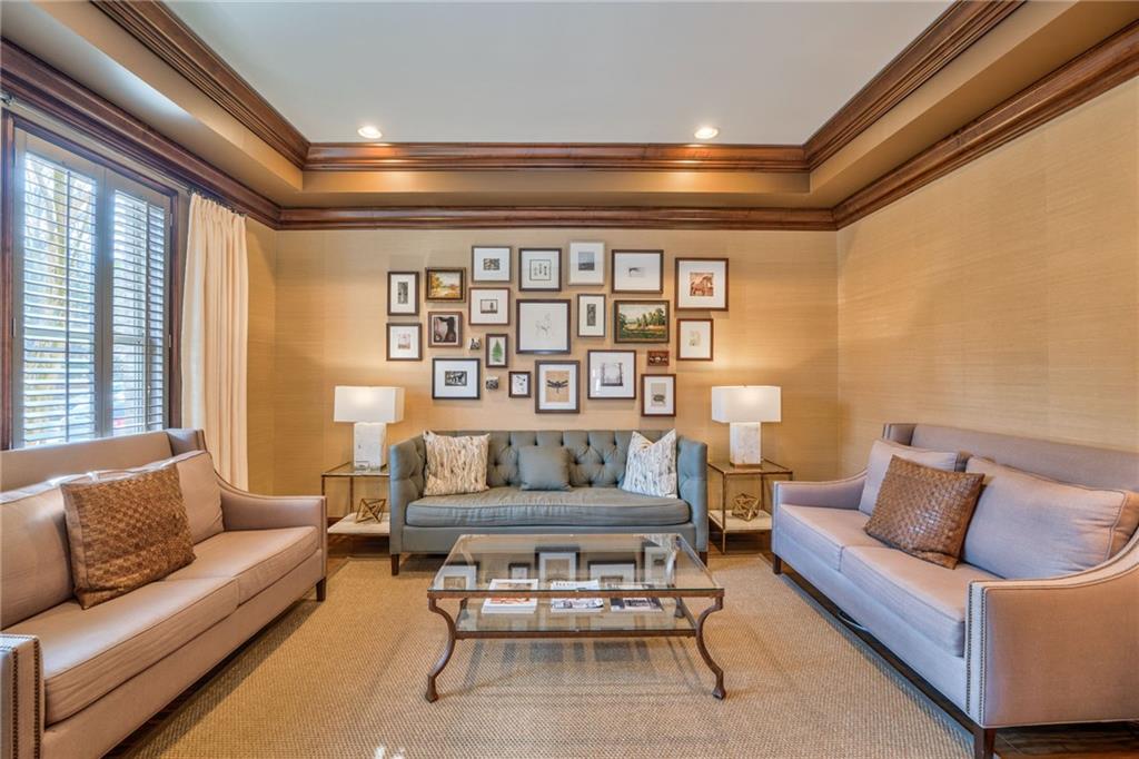 Living room with crown molding and a healthy amount of sunlight