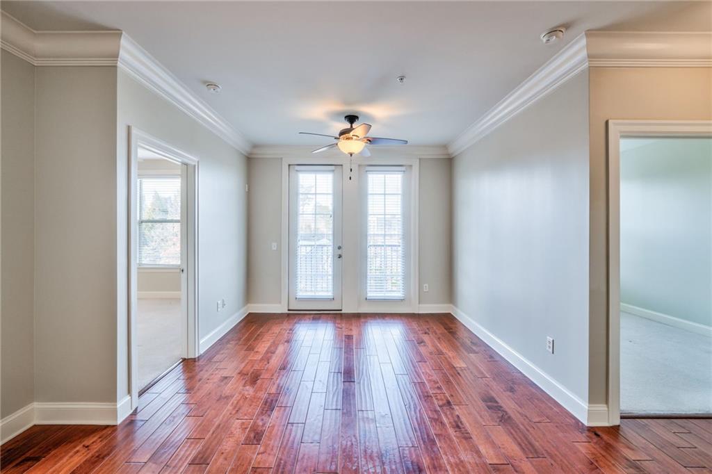Doorway to outside with dark hardwood / wood-style floors, ornamental molding, french doors, and ceiling fan