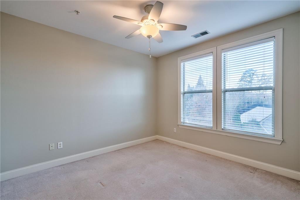 Unfurnished room with light carpet and ceiling fan