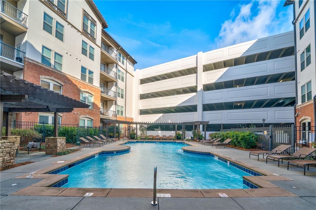 View of swimming pool with a pergola