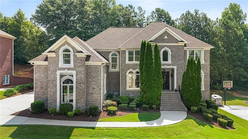 Stately brick facade residence featuring multiple gables and arched windows