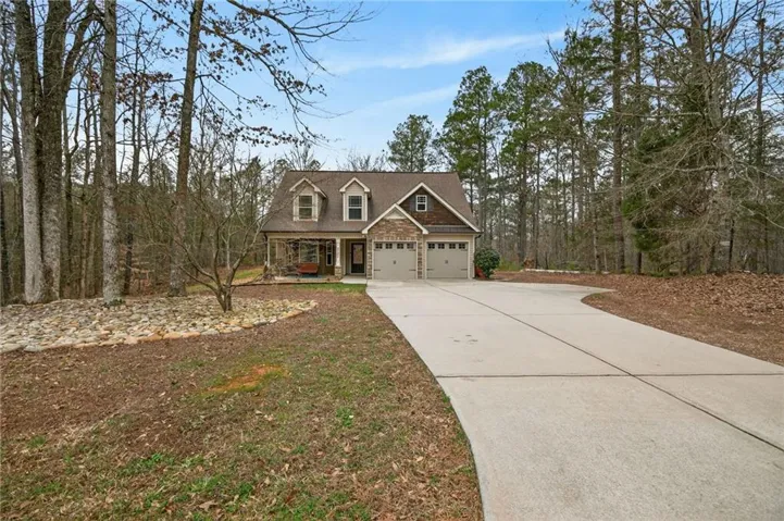 View of front of house featuring driveway and a porch