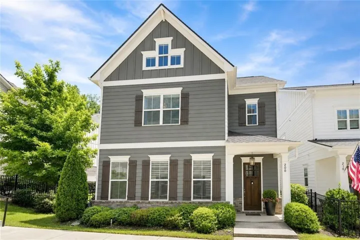 Two-story home with gray siding and white trim