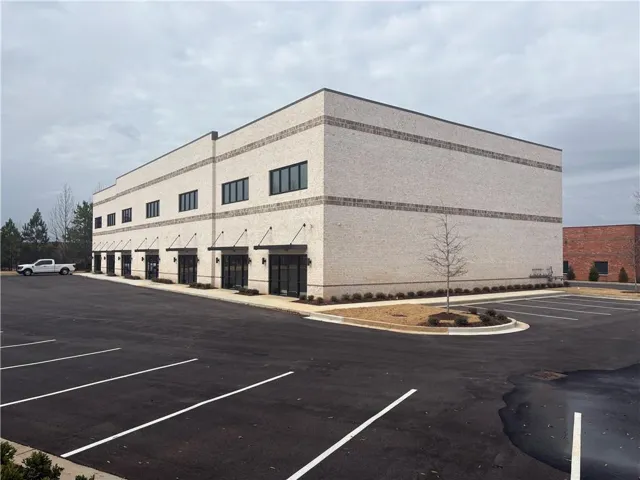 Contemporary light-colored brick exterior with dark trim windows