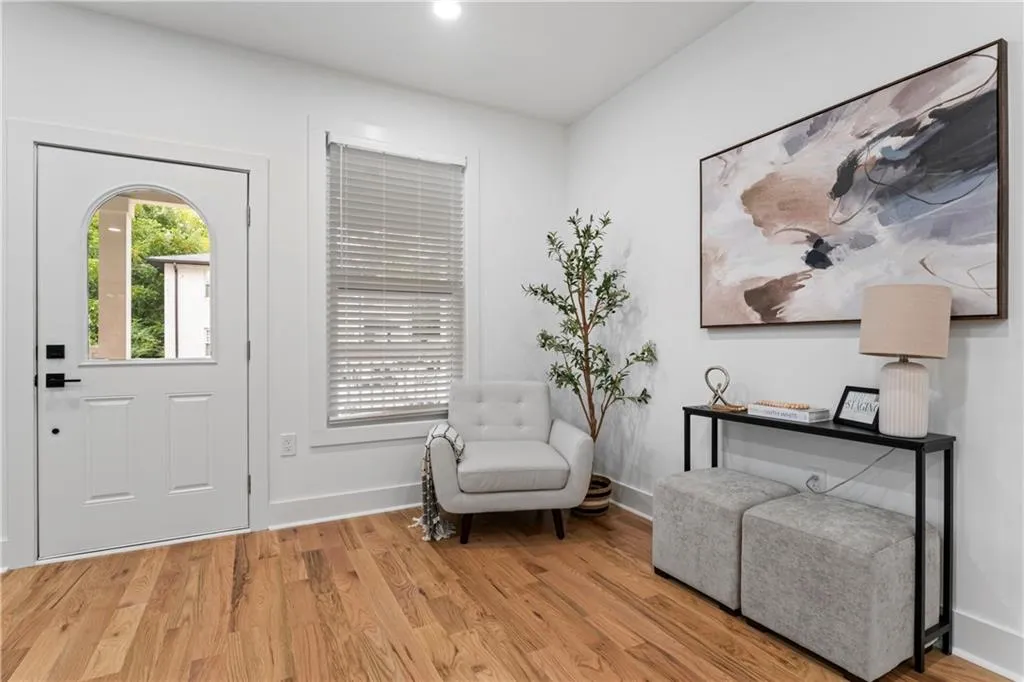 Entryway with wood finished floors and recessed lighting