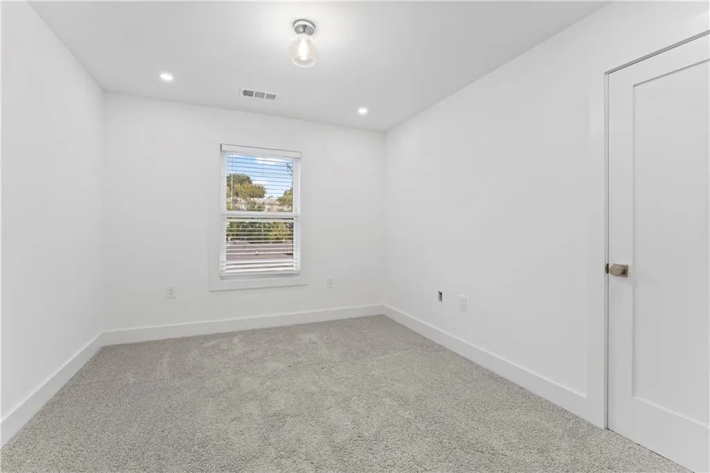 Unfurnished room featuring light carpet and recessed lighting