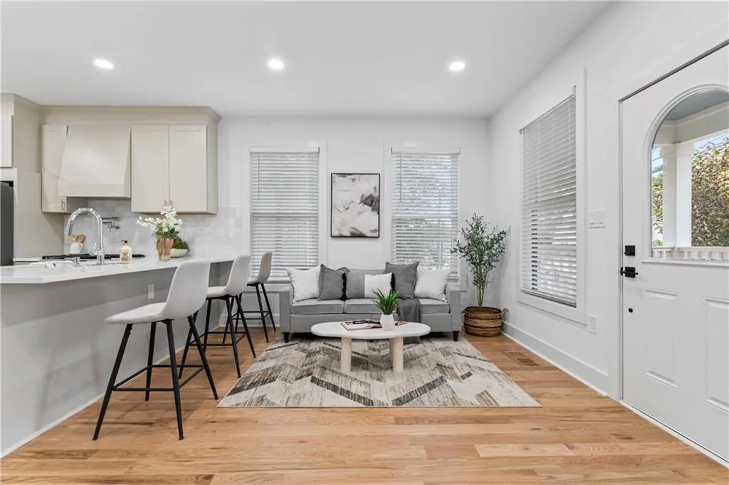 Living area featuring light wood-style flooring, recessed lighting, and healthy amount of natural light
