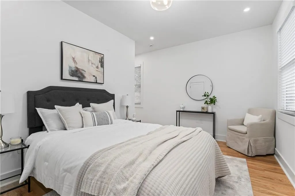 Bedroom with wood finished floors and recessed lighting