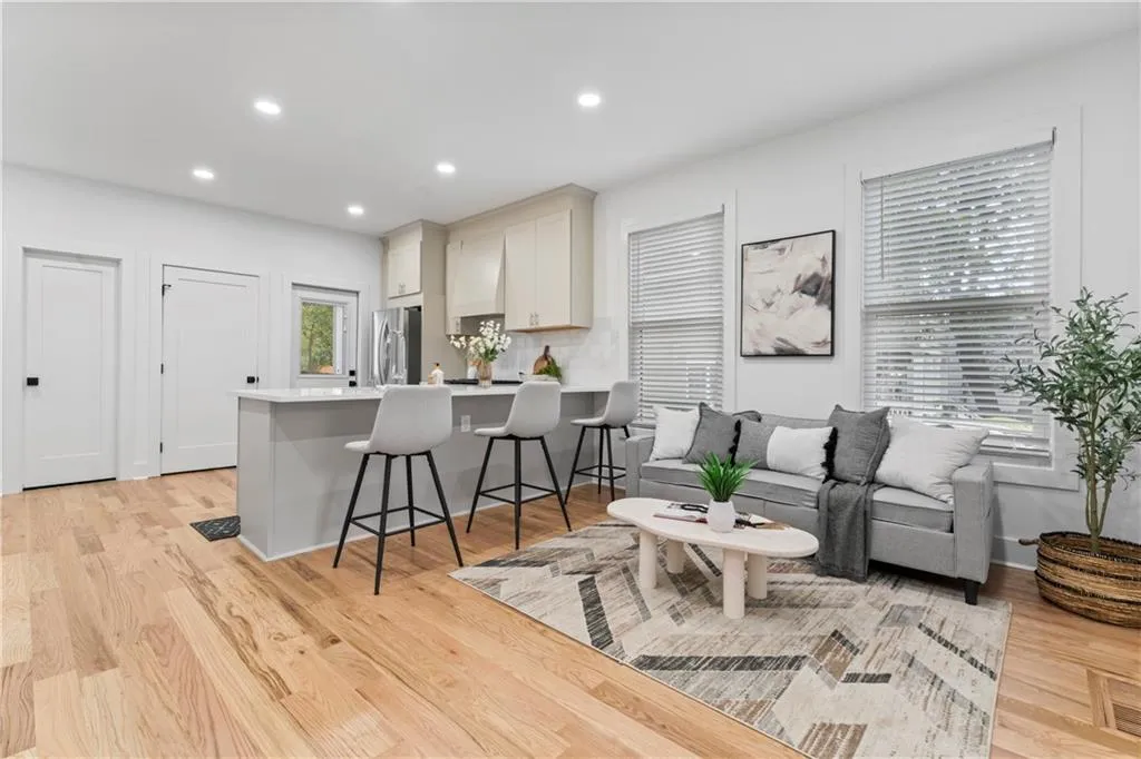 Living room with recessed lighting and light wood-style flooring