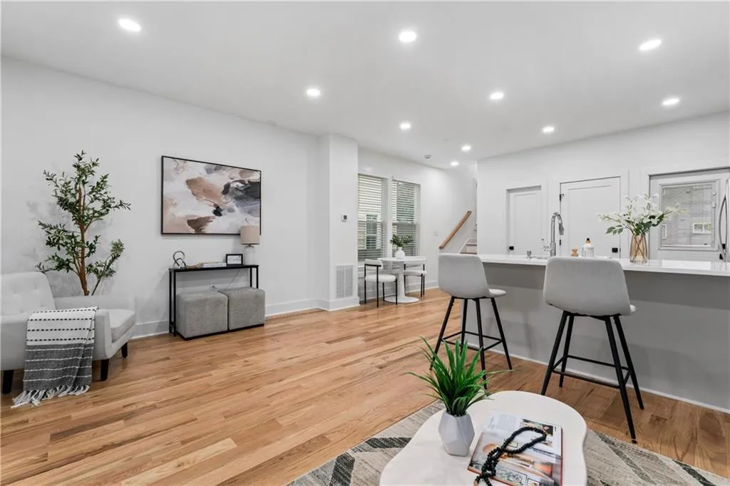 Living room with recessed lighting, light wood-style flooring, and stairway