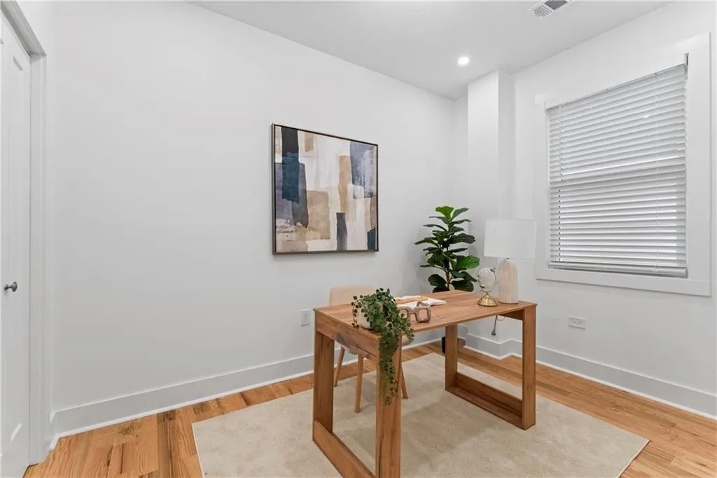 Home office featuring light wood finished floors and recessed lighting