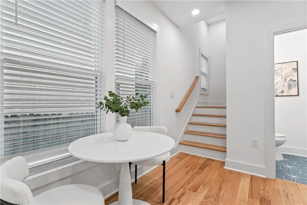Dining area featuring stairs, light wood finished floors, and recessed lighting