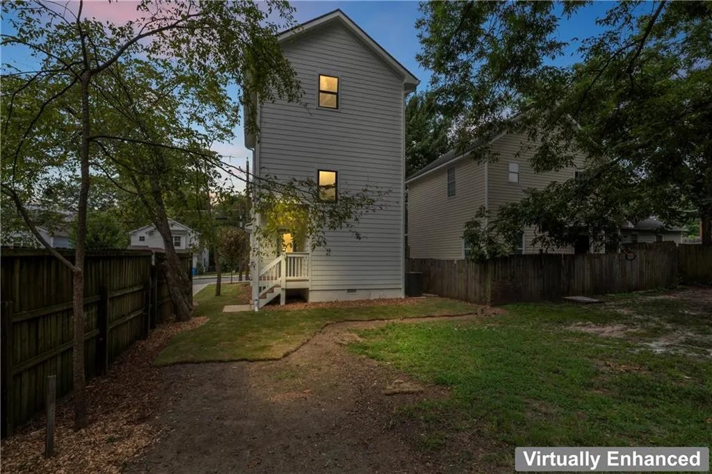 Back of property featuring a fenced backyard and crawl space