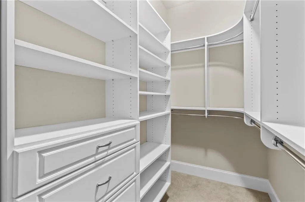 Spacious closet with light carpet