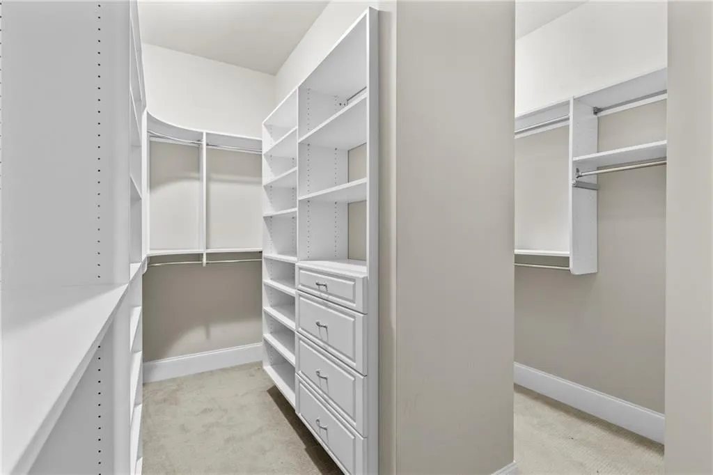 Spacious closet with light colored carpet