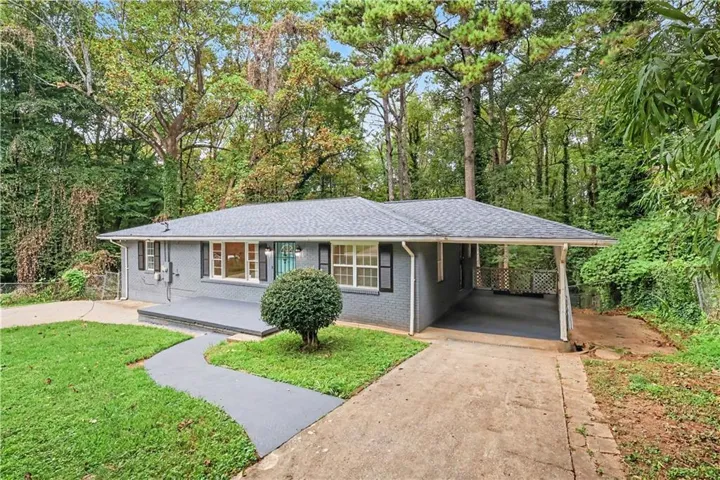 Brick exterior with a covered front porch and a paved walkway