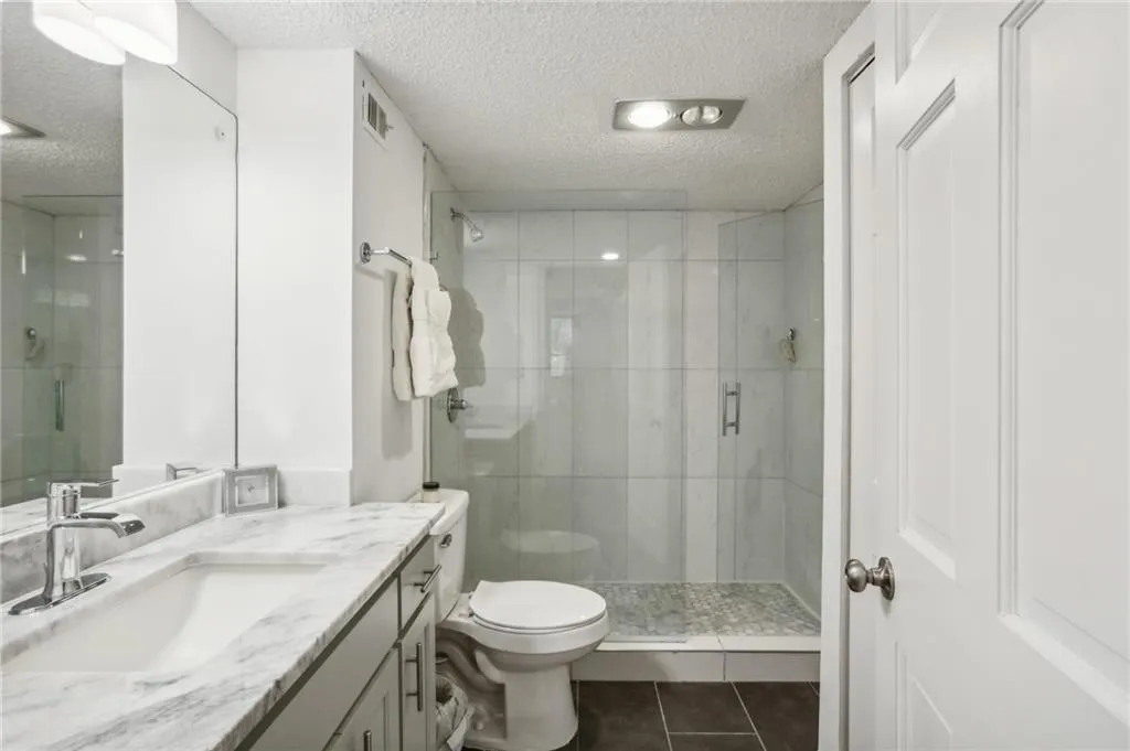 Primary bathroom offers large reach in closet.