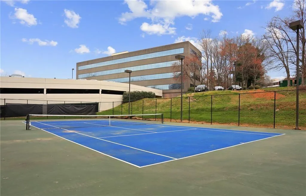 View of tennis court with community basketball court