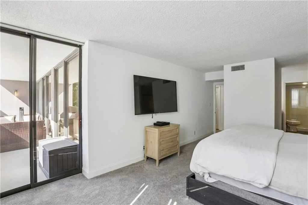 Oversized primary bedroom with access to patio