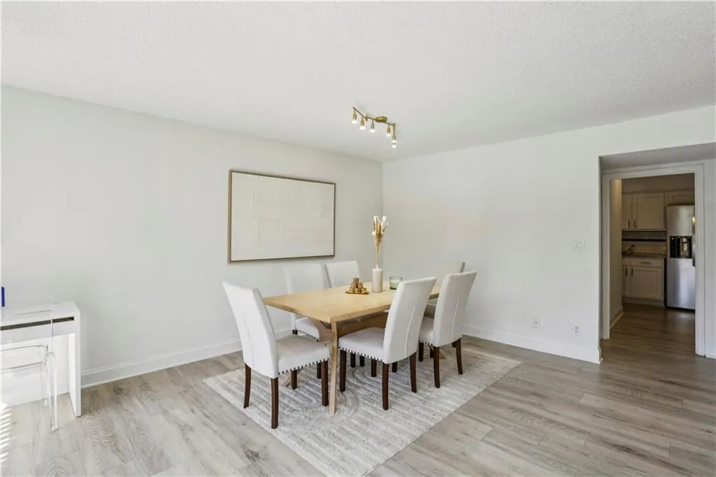 Dining space featuring light wood finished floors and a textured ceiling