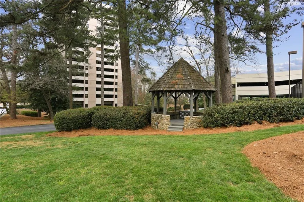 View of home's community with a patio area, a gazebo, and a lawn