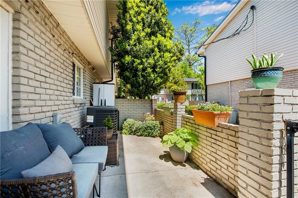 View of patio with central AC and an outdoor hangout area
