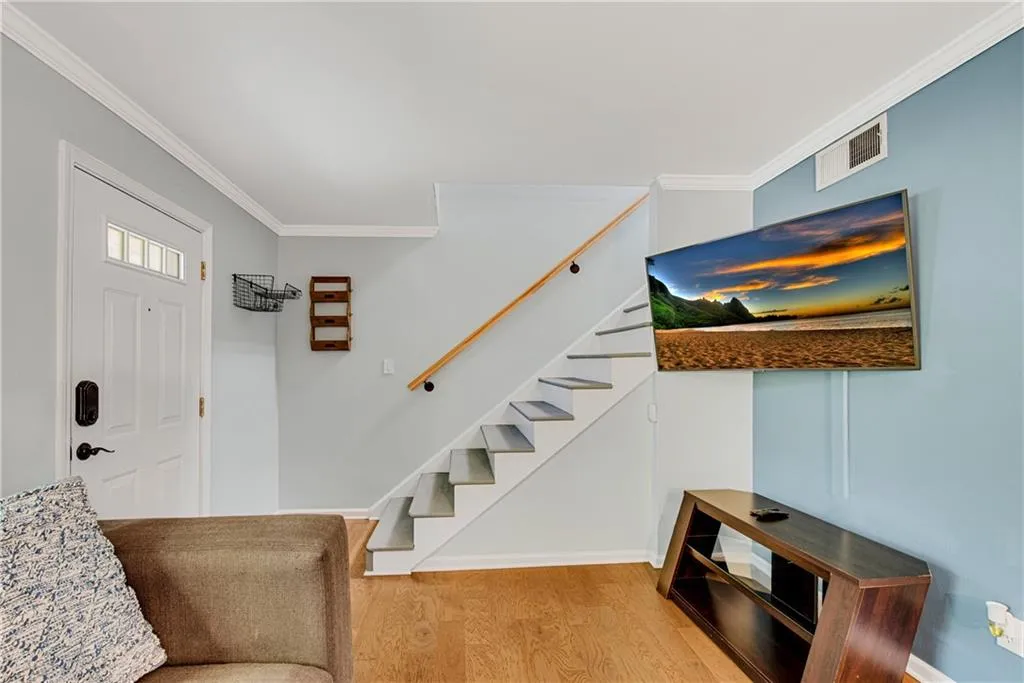 Foyer featuring ornamental molding and light hardwood / wood-style flooring