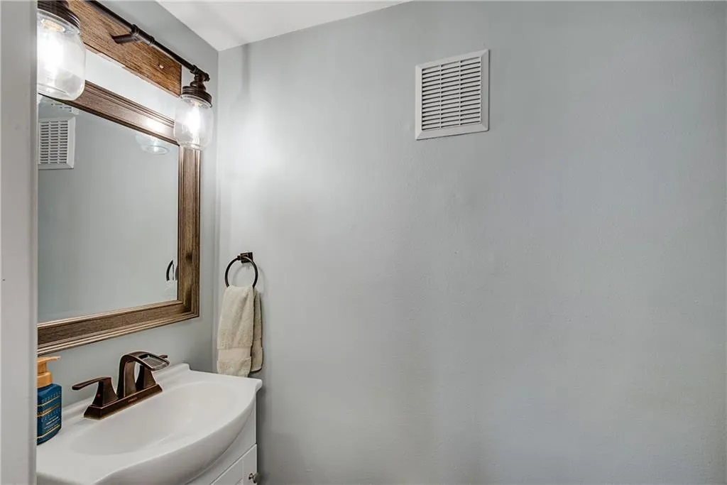 Bathroom featuring vanity with extensive cabinet space